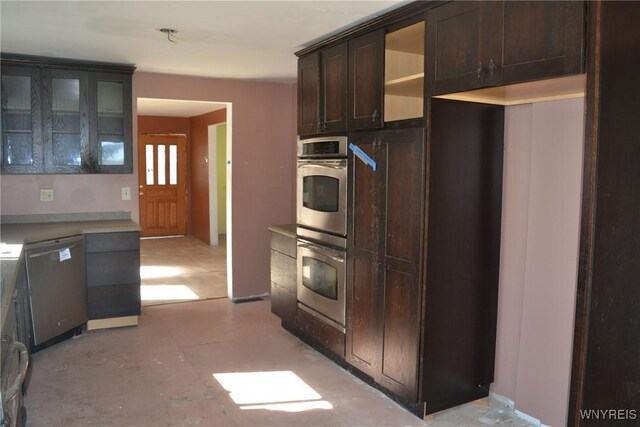 2386 Main St, Collins, NY 14034 - kitchen featuring light floors, glass insert cabinets, dark brown cabinetry, and appliances with stainless steel finishes