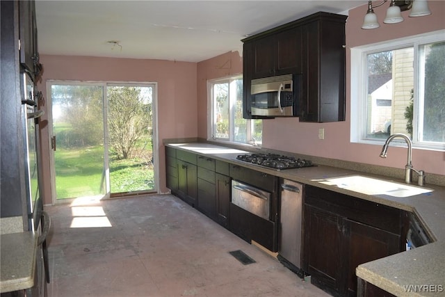2386 Main St, Collins, NY 14034 - kitchen featuring a warming drawer, appliances with stainless steel finishes, a sink, and a healthy amount of sunlight