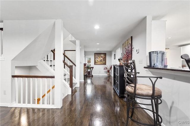 hallway with stairway, baseboards, wood finished floors, and recessed lighting