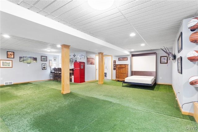 carpeted bedroom featuring baseboards, decorative columns, visible vents, and recessed lighting