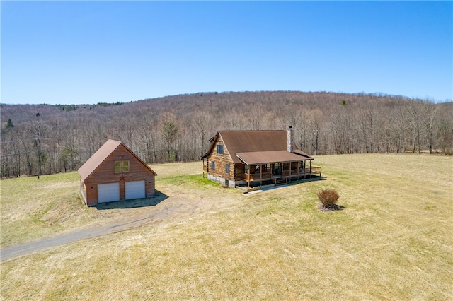 birds eye view of property with a forest view