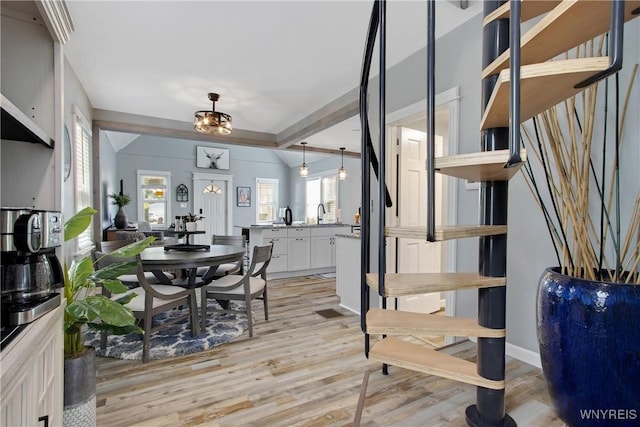 dining room with baseboards, a healthy amount of sunlight, and light wood-style floors