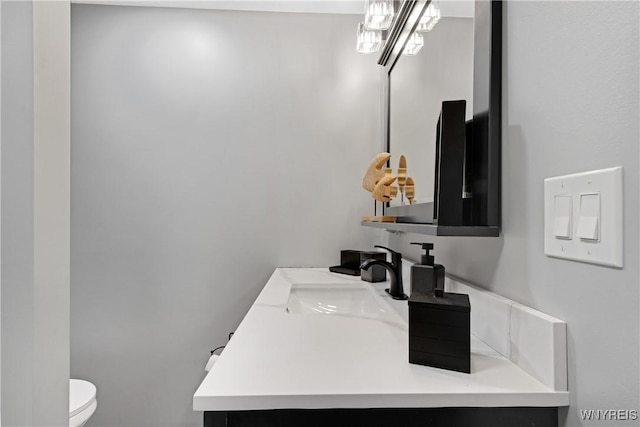 half bathroom featuring toilet and vanity
