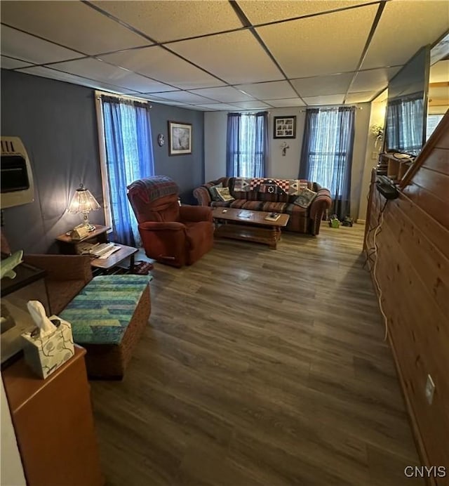 living room with a paneled ceiling and wood finished floors