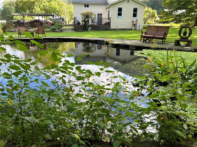 view of yard with a garden pond and a wooden deck