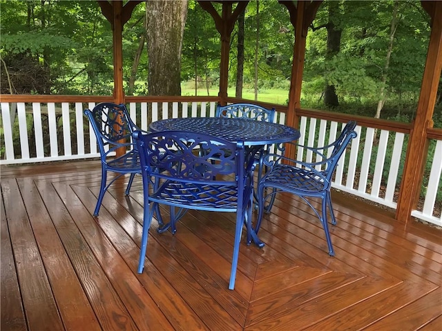 wooden terrace with outdoor dining space