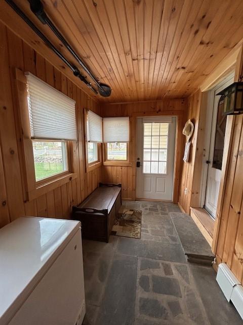 mudroom featuring wood ceiling, rail lighting, and wooden walls