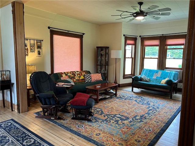living area with ceiling fan and hardwood / wood-style floors
