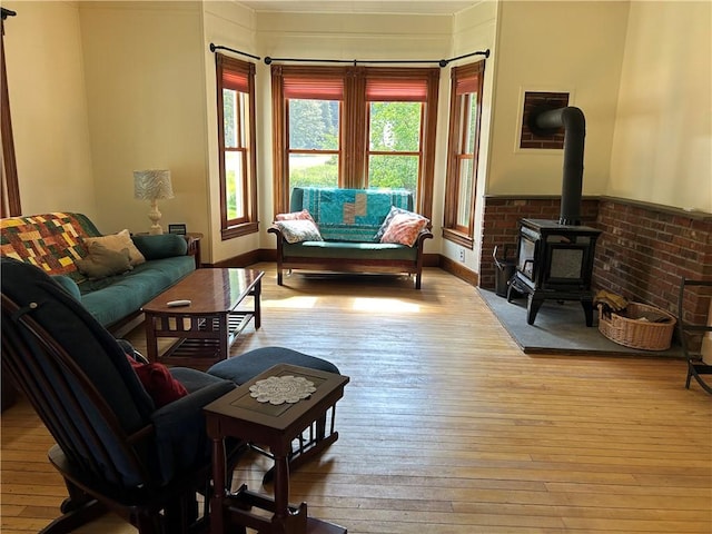 living room featuring hardwood / wood-style flooring and a wood stove