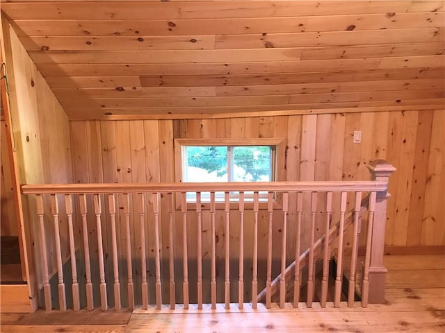 additional living space featuring wooden ceiling and wood walls