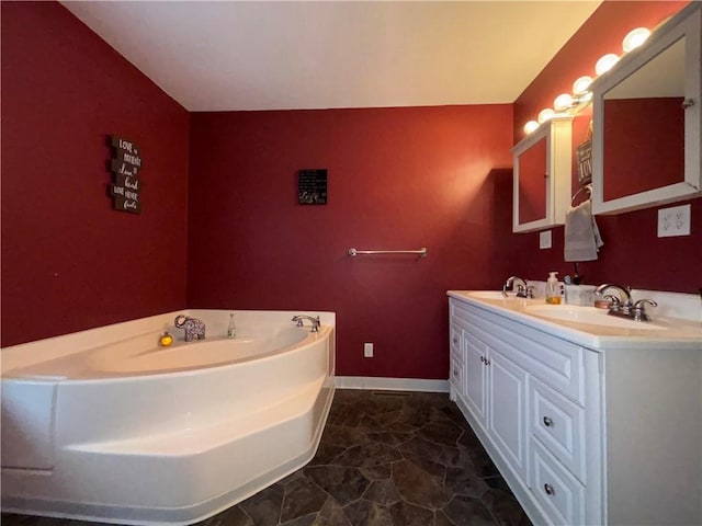full bath featuring double vanity, a garden tub, baseboards, and a sink