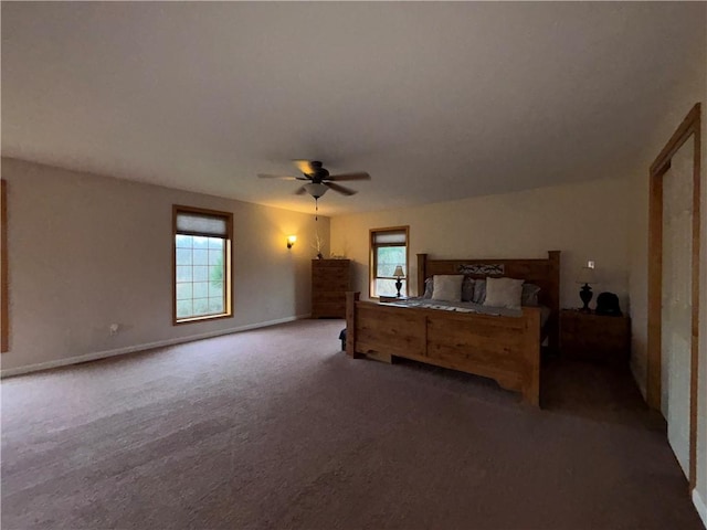 bedroom with ceiling fan, baseboards, and carpet