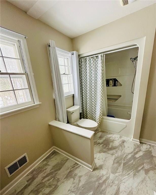 bathroom with marble finish floor, visible vents, toilet, shower / tub combo with curtain, and baseboards