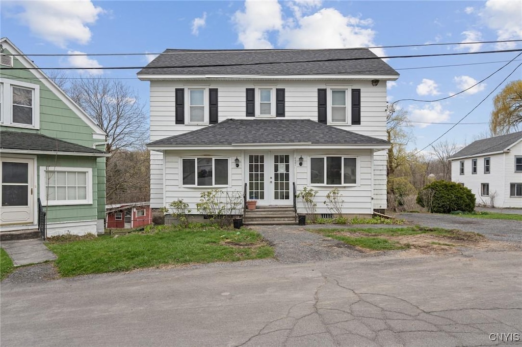 view of front of property with french doors, roof with shingles, and entry steps