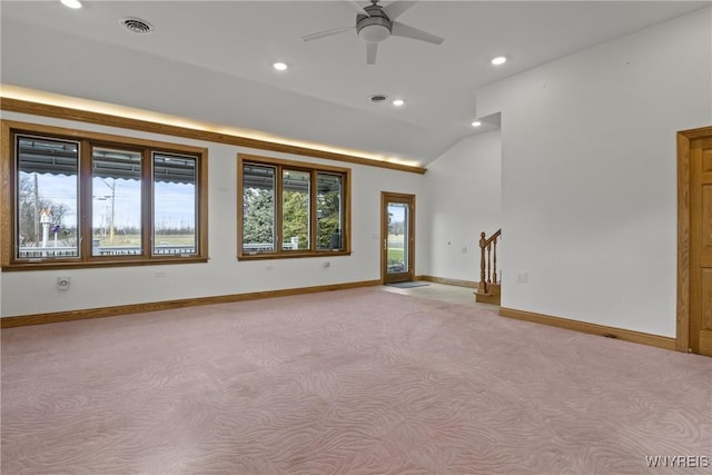 spare room featuring recessed lighting, lofted ceiling, baseboards, and light carpet