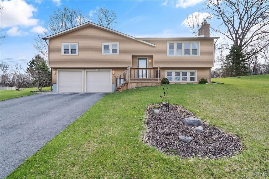 4856 Burrstone Rd, Onondaga, NY 13215 - bi-level home with a front lawn, a chimney, aphalt driveway, and a garage