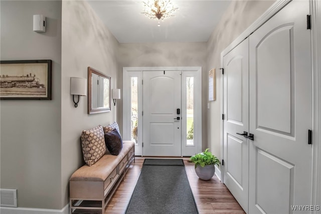 entrance foyer featuring baseboards, visible vents, and dark wood-style floors