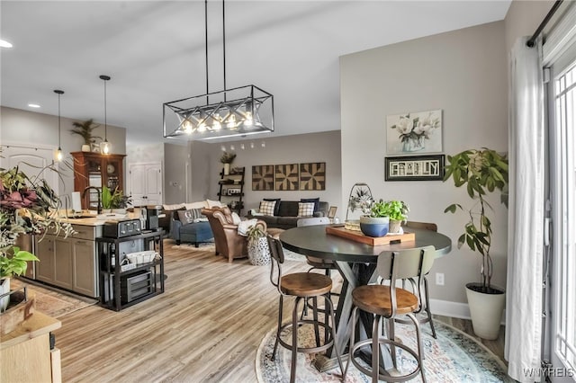 dining space with recessed lighting, light wood-style floors, and baseboards