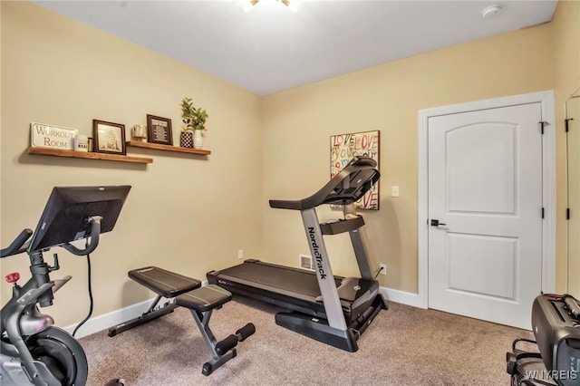 workout room featuring baseboards and carpet