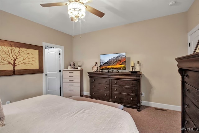 carpeted bedroom featuring baseboards, a ceiling fan, and visible vents