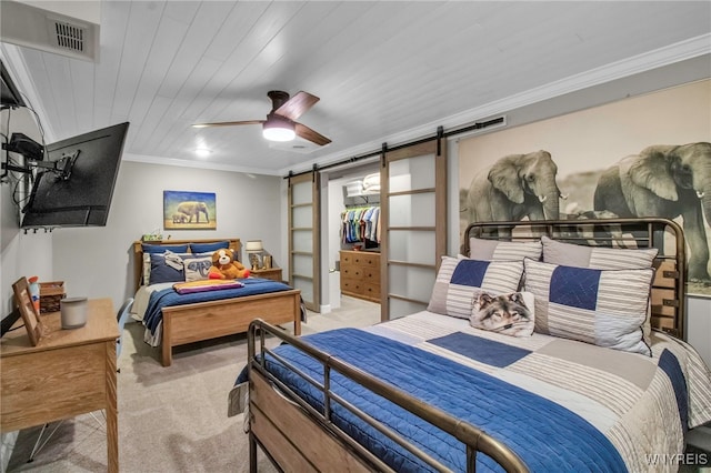 bedroom featuring a barn door, visible vents, a ceiling fan, light carpet, and crown molding