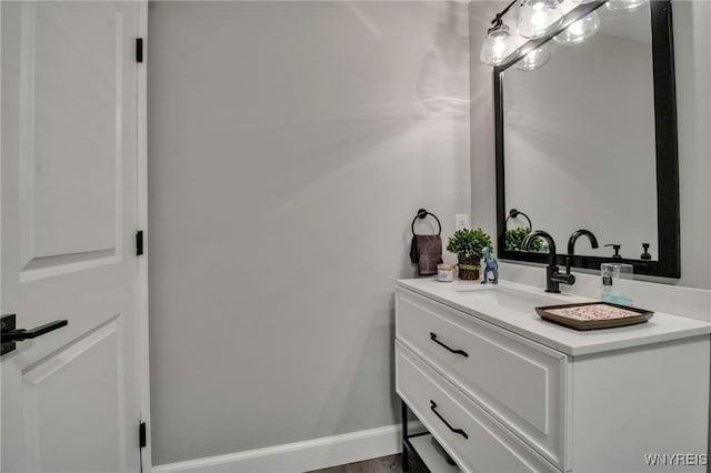 bathroom with baseboards and vanity