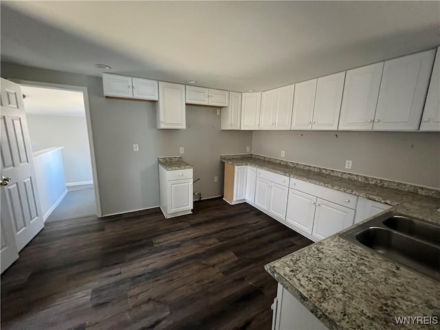 180 Spalding St, Lockport-City, NY 14094 - kitchen featuring dark wood-style flooring, baseboards, white cabinetry, and a sink