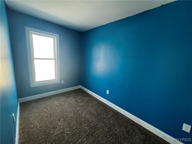 180 Spalding St, Lockport-City, NY 14094 - spare room with dark colored carpet and baseboards