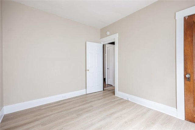 empty room featuring light wood-style floors and baseboards