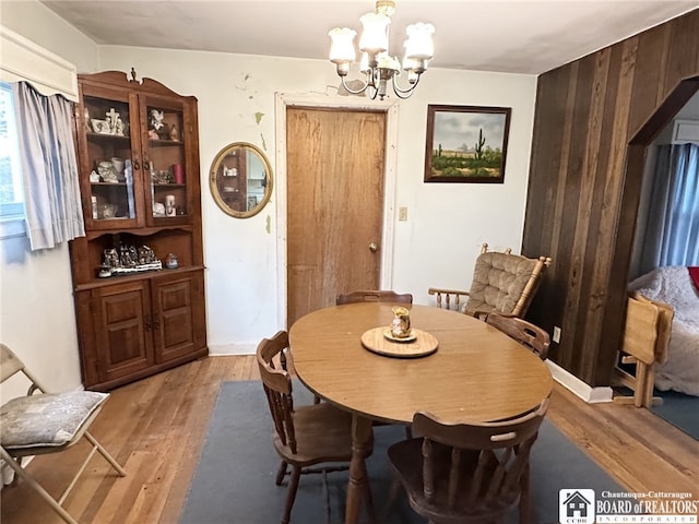 dining room with an inviting chandelier and wood finished floors