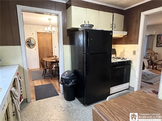 kitchen with range hood, ornamental molding, a notable chandelier, gas stove, and freestanding refrigerator