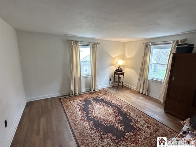 interior space with baseboards and wood finished floors