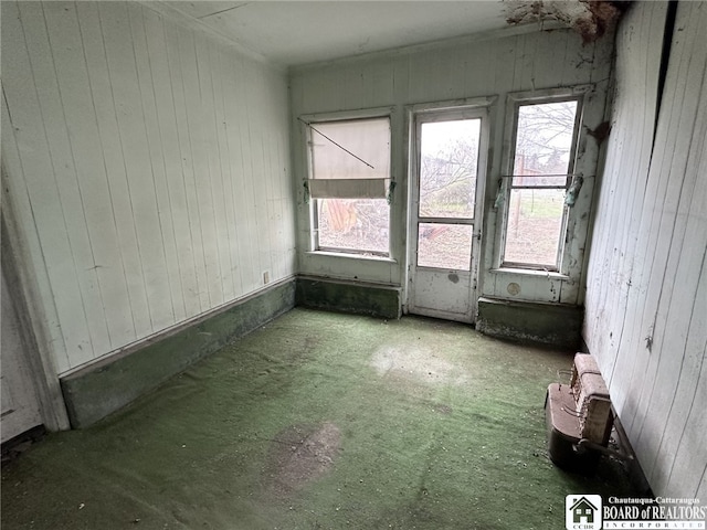 spare room with wood walls