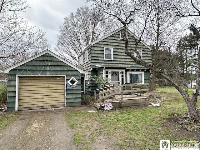 view of front of home with aphalt driveway and a garage
