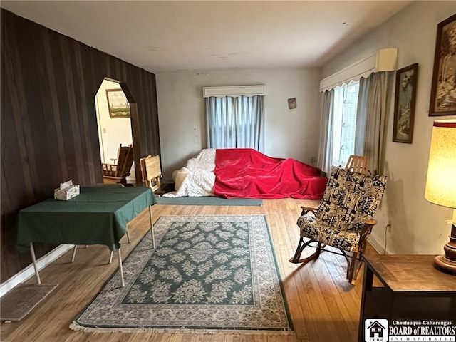living room featuring wooden walls and wood finished floors