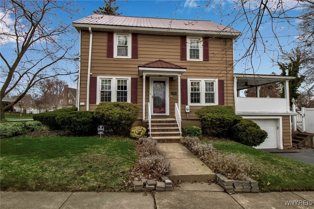 4301 Lewiston Rd, Niagara Falls, NY 14305 - colonial house with a garage, a front lawn, driveway, and metal roof