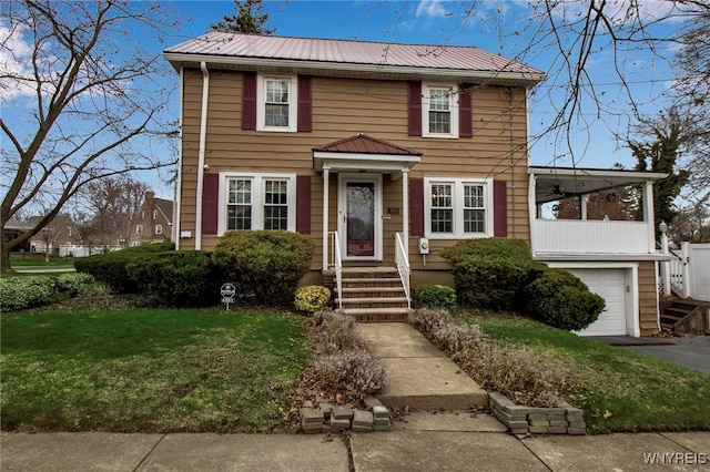 4301 Lewiston Rd, Niagara Falls, NY 14305 - colonial house with a garage, a front lawn, driveway, and metal roof
