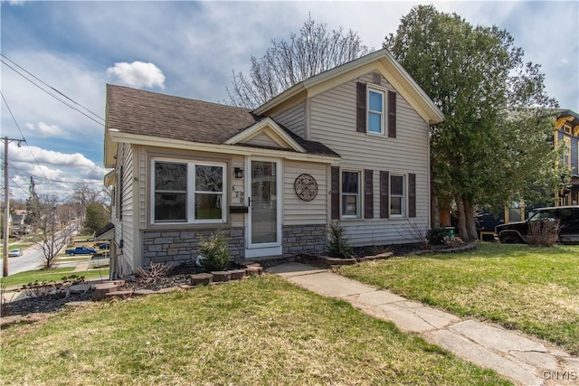 620 W St, Wilna, NY 13619 - traditional home with stone siding, a front lawn, and a shingled roof