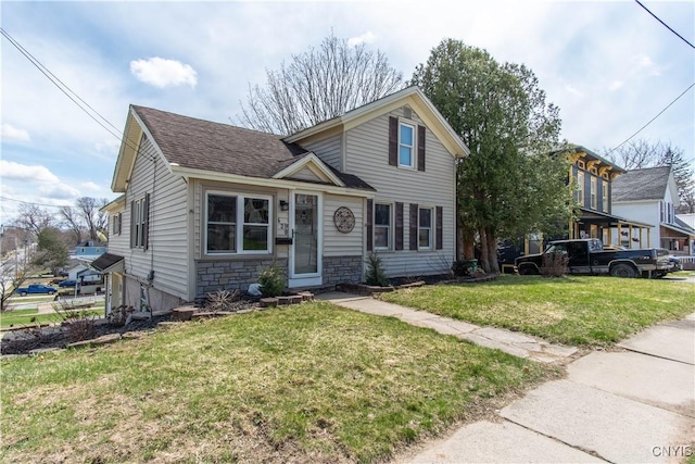620 W St, Wilna, NY 13619 - traditional-style home featuring stone siding, a shingled roof, and a front lawn