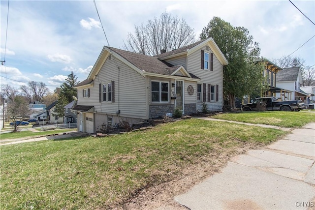 620 W St, Wilna, NY 13619 - traditional-style house featuring a front lawn, stone siding, a shingled roof, and a garage