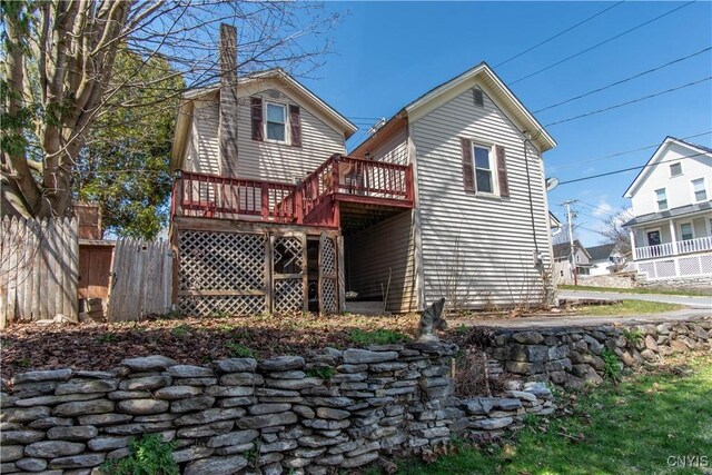 620 W St, Wilna, NY 13619 - back of house featuring fence, a wooden deck, and a chimney