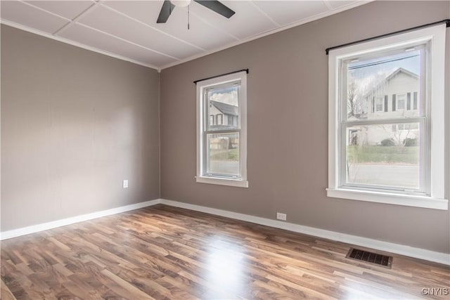 620 W St, Wilna, NY 13619 - spare room featuring wood finished floors, visible vents, a wealth of natural light, and ornamental molding
