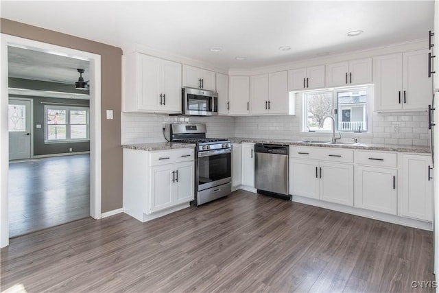 620 W St, Wilna, NY 13619 - kitchen featuring stainless steel appliances, wood finished floors, a ceiling fan, a sink, and white cabinetry