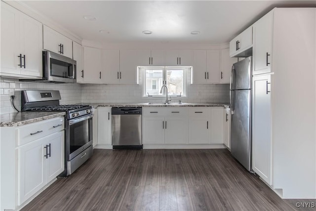 620 W St, Wilna, NY 13619 - kitchen featuring dark wood-style flooring, light stone countertops, appliances with stainless steel finishes, and white cabinetry
