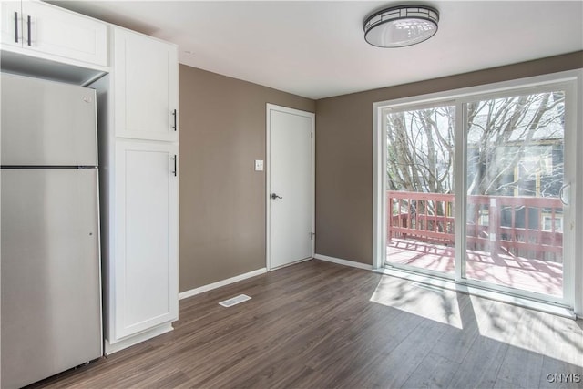 620 W St, Wilna, NY 13619 - unfurnished dining area with dark wood finished floors, baseboards, and visible vents