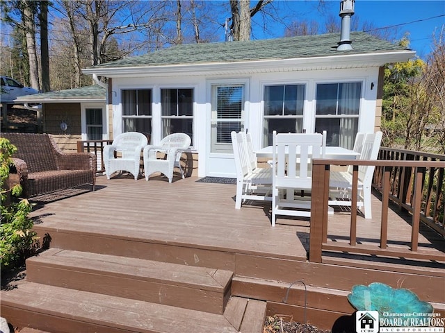 wooden terrace with outdoor dining area