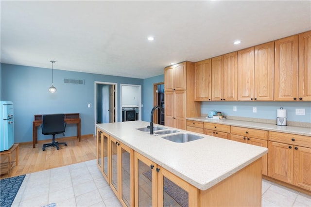 739 Pre Emption Rd, Geneva-City, NY 14456 - kitchen featuring light countertops, a kitchen island with sink, visible vents, and a sink