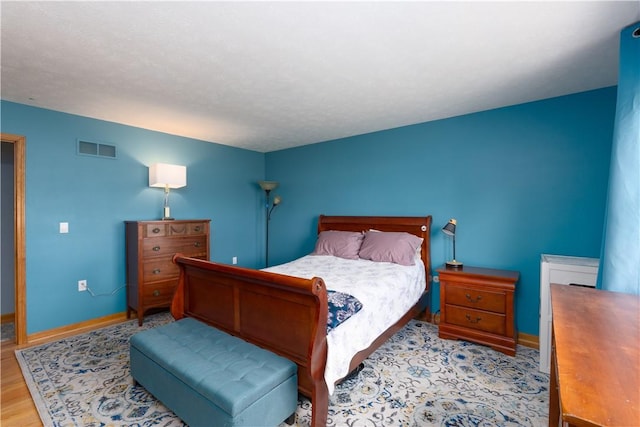 739 Pre Emption Rd, Geneva-City, NY 14456 - bedroom with baseboards, wood finished floors, and visible vents