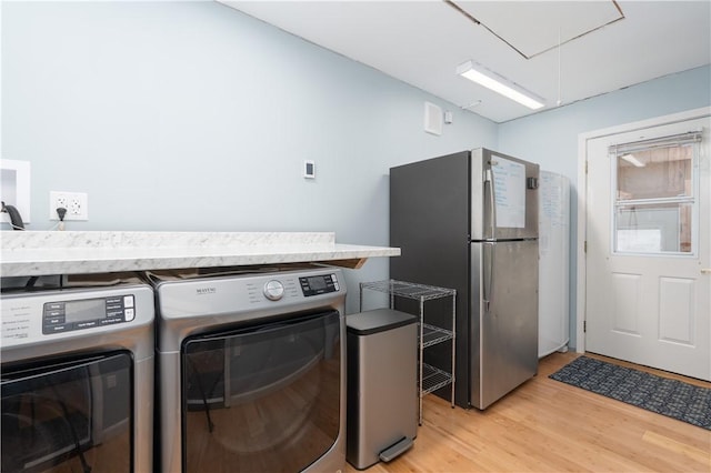 739 Pre Emption Rd, Geneva-City, NY 14456 - washroom with attic access, washing machine and dryer, light wood-style floors, and laundry area