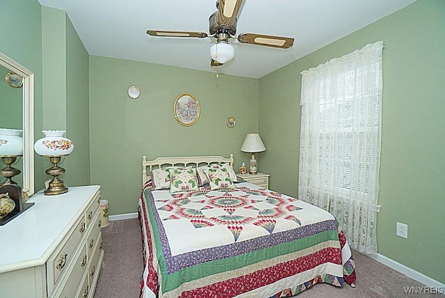 bedroom with dark carpet, ceiling fan, and baseboards